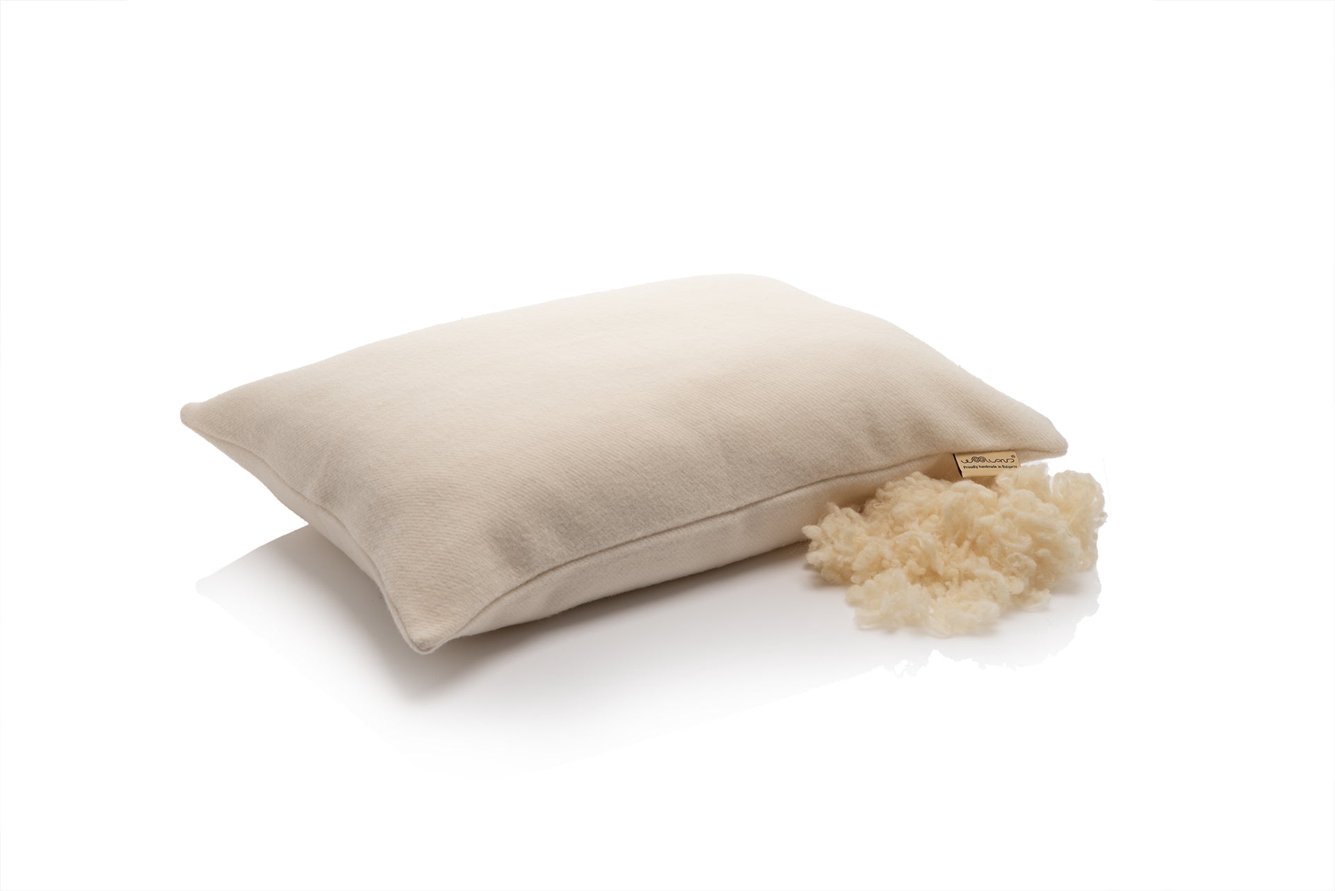 Beige pillow with sheep wool on a white background by Woolland