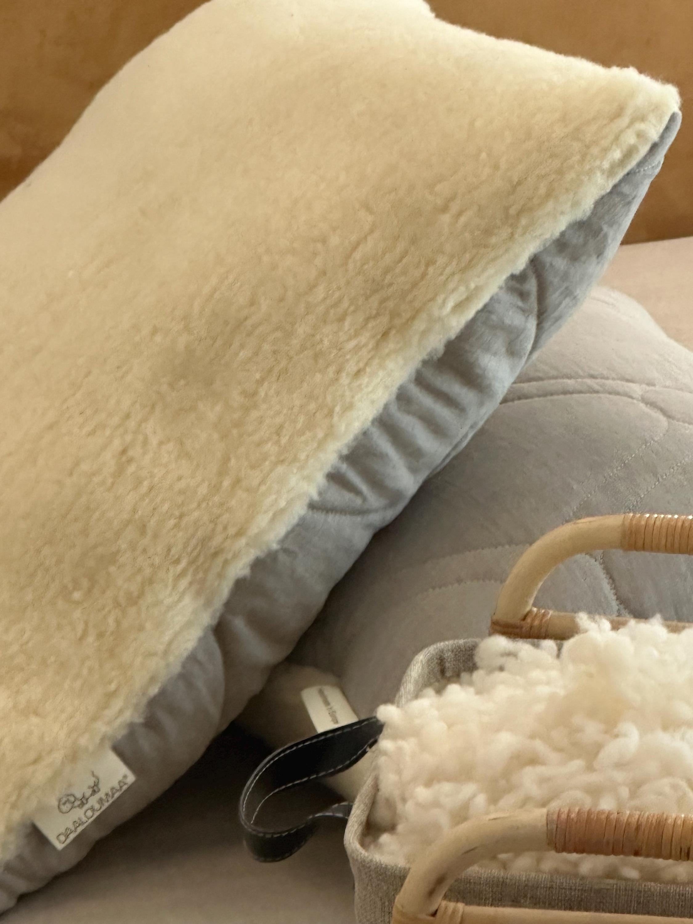 Close-up of a Woolland fluffy pillow with merino wool surface, placed on bed.