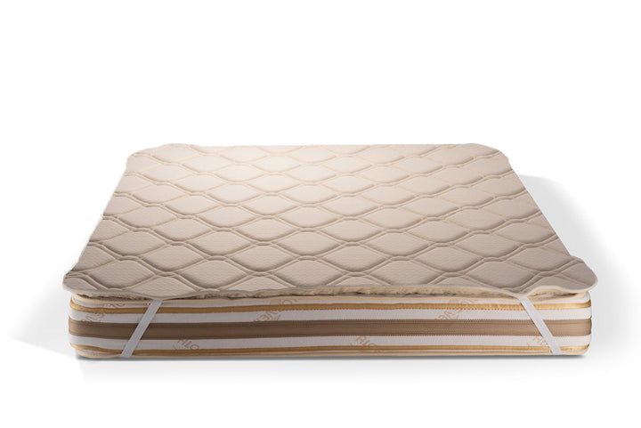 Hemp and merino wool mattress topper on a white background by Woolland