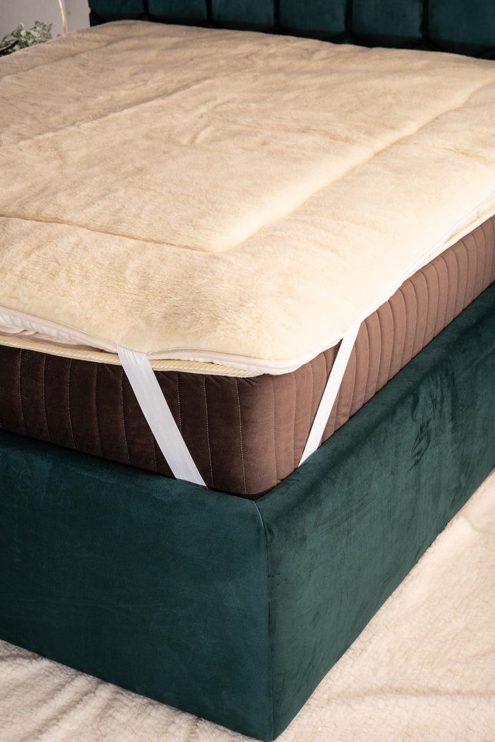 Mattress with merino wool mattress topper on a bed. Handcrafted by Woolland