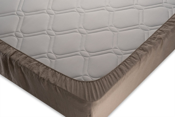 Corner close up photo of linen fitted sheet made by the Woolland from natural linen colored fabric.