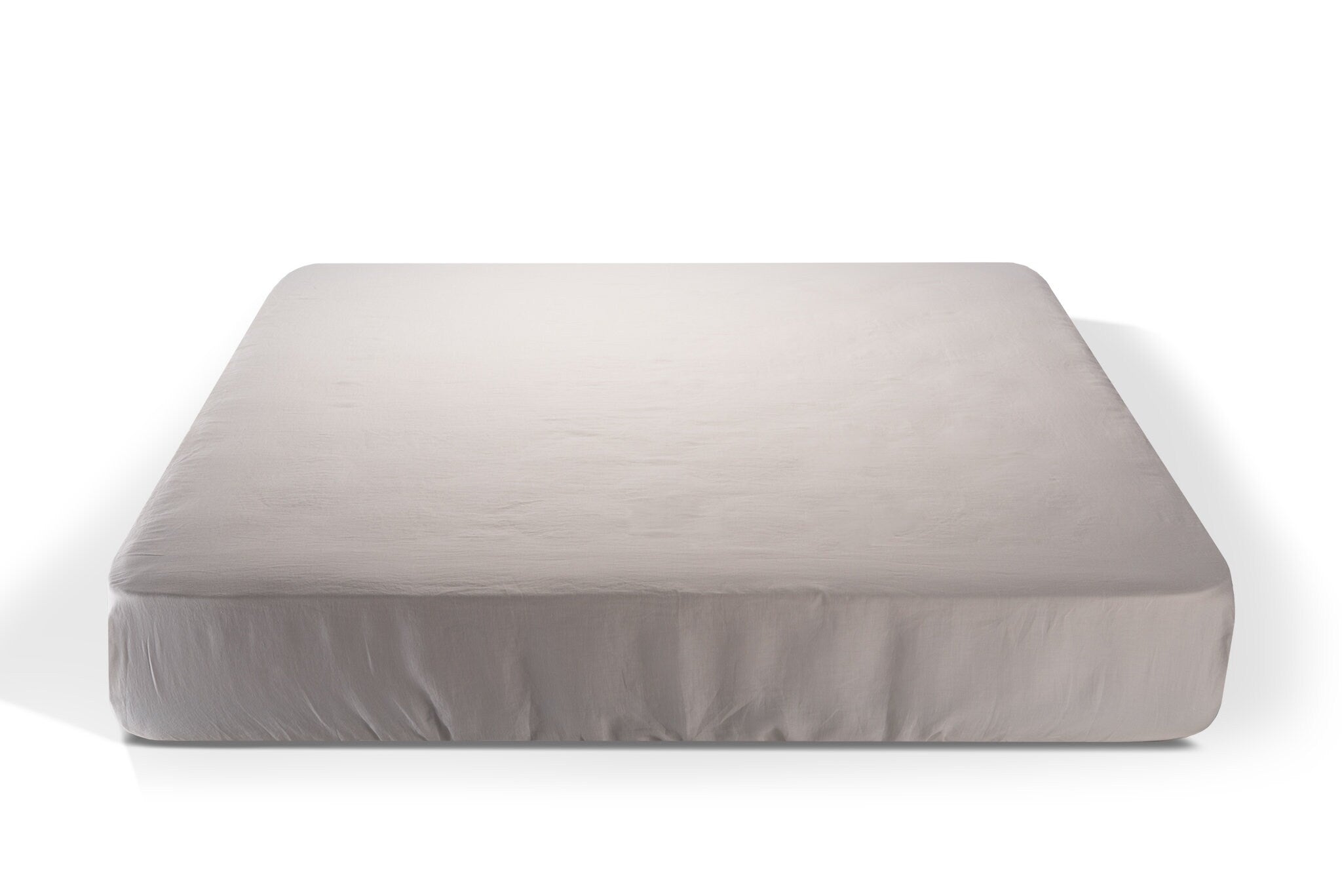 white linen fitted sheet on a white background. Handcrafted by Woolland