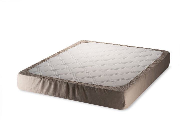 Mattress with a fitted natural linen color sheet on a white background