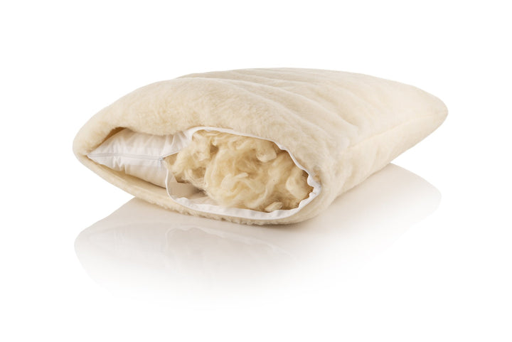 Merino wool pillow with visible inner stuffing on a white background
