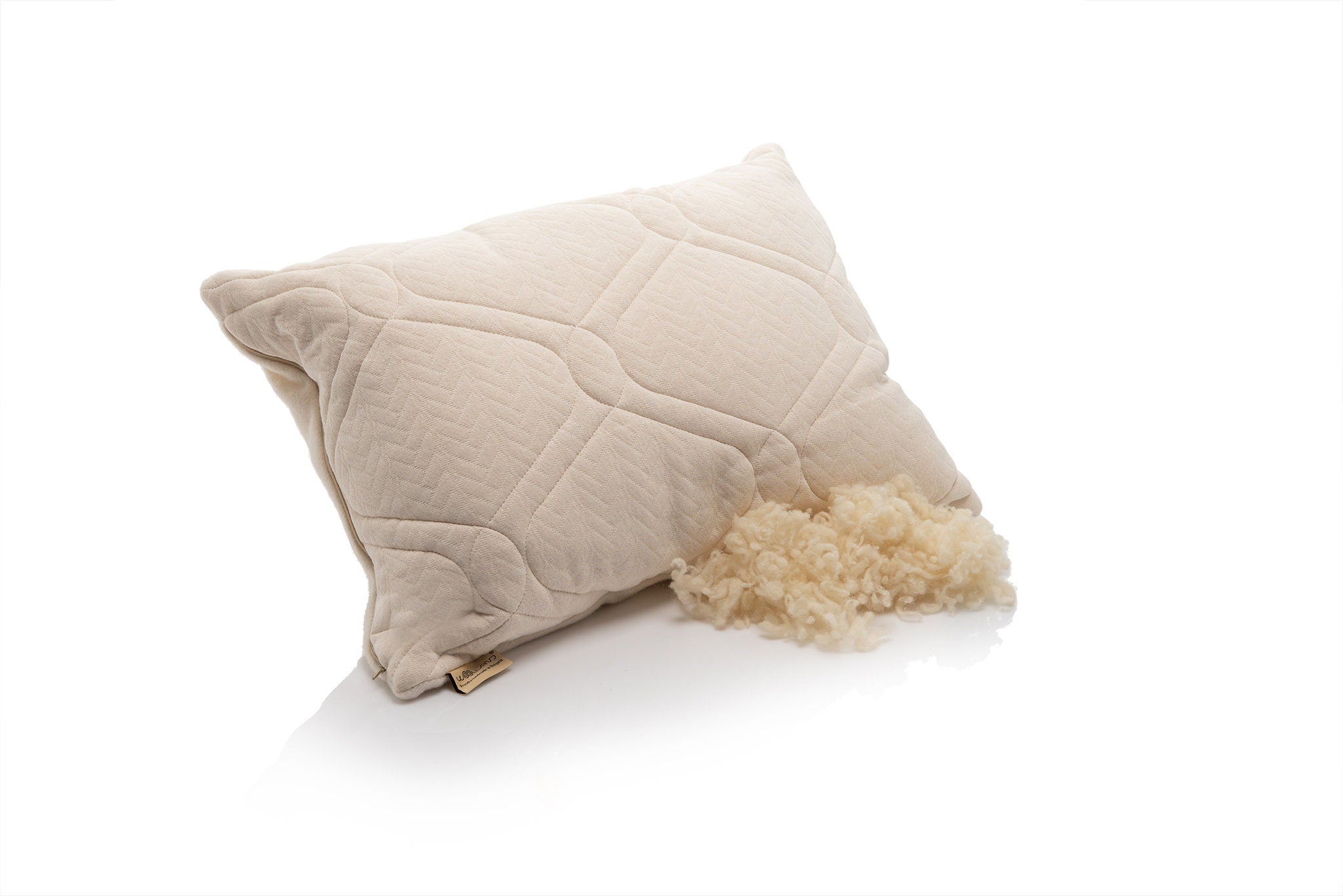 Hemo and organic cotton quilted pillow with textured surface and raw wool filling on a white background by the Woolland