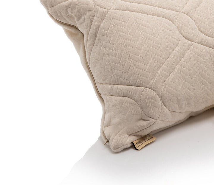 Hemo and organic cotton quilted pillow with a Woolland brand tag on a white background