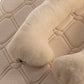 The Woolland merino wool pregnancy pillow on a quilted surface 