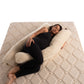 Person lying on a u-shaped merino wool maternity pillow handmade by Woolland