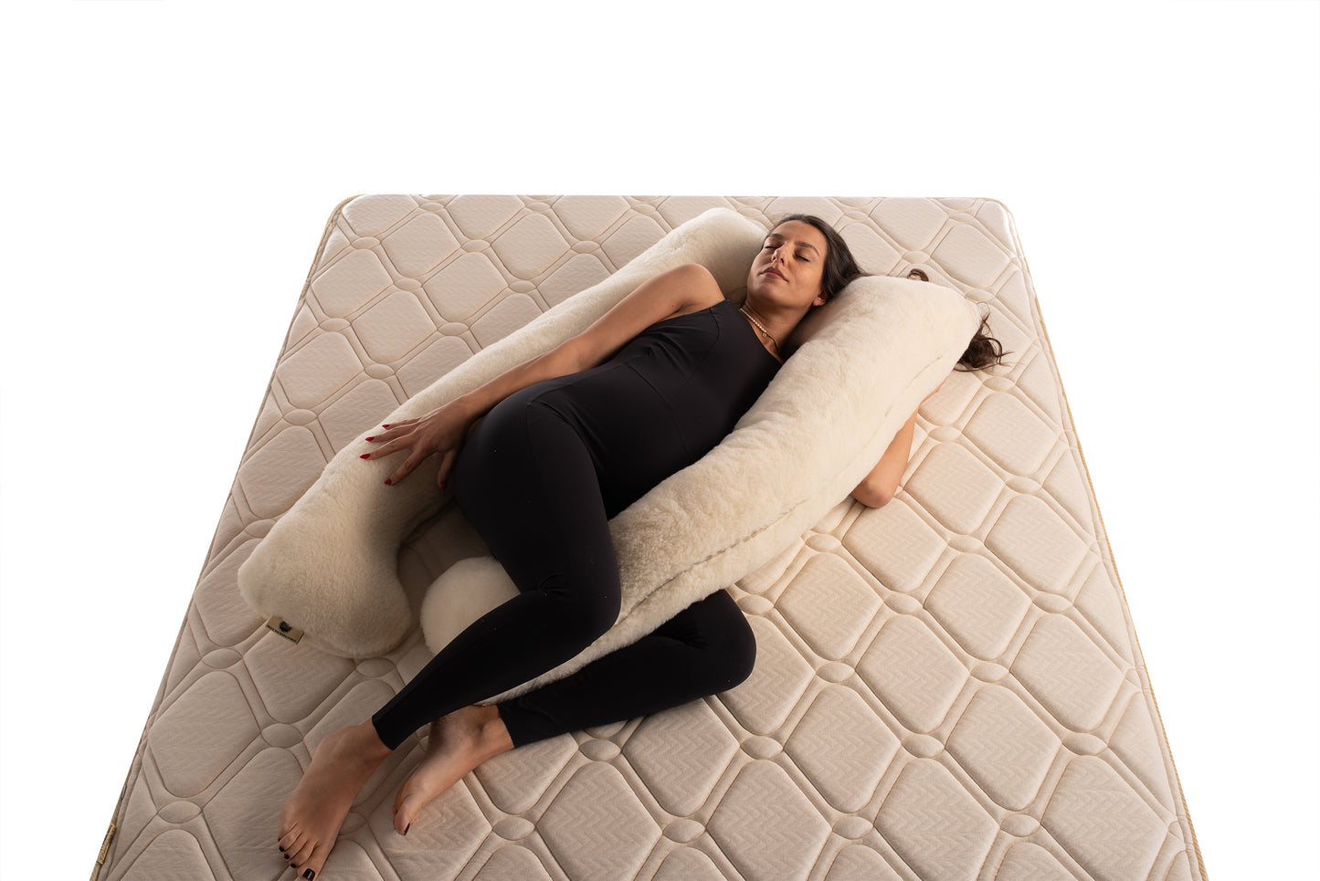 Pregnant lady laying on u-shaped merino wool maternity pillow by Woolland