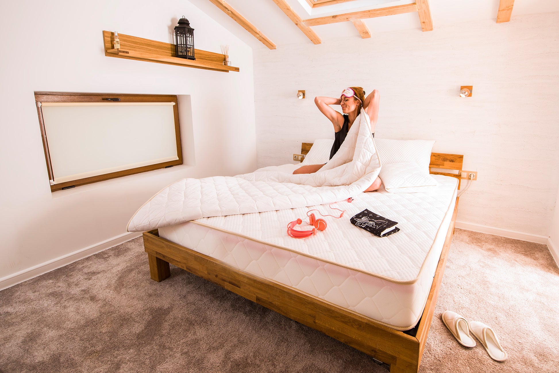 Woman lying on a bed with cotton sateen and wool batting quilt duvet insert made by woolland.