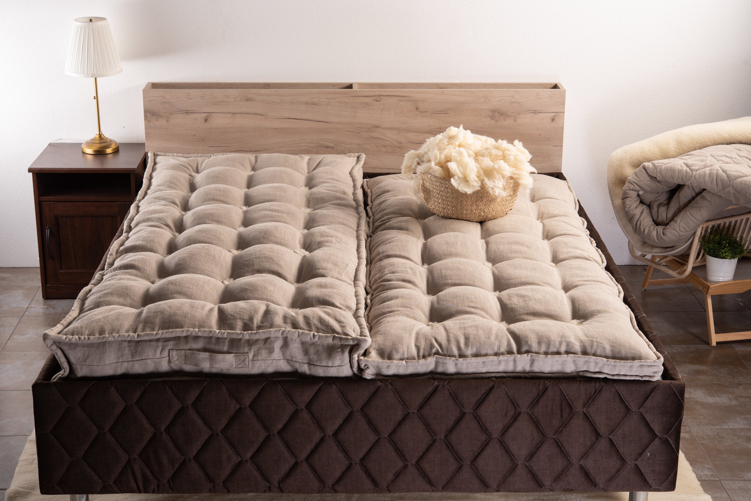 Two pieces of Natural handmade linen and wool mattresses on a bed 