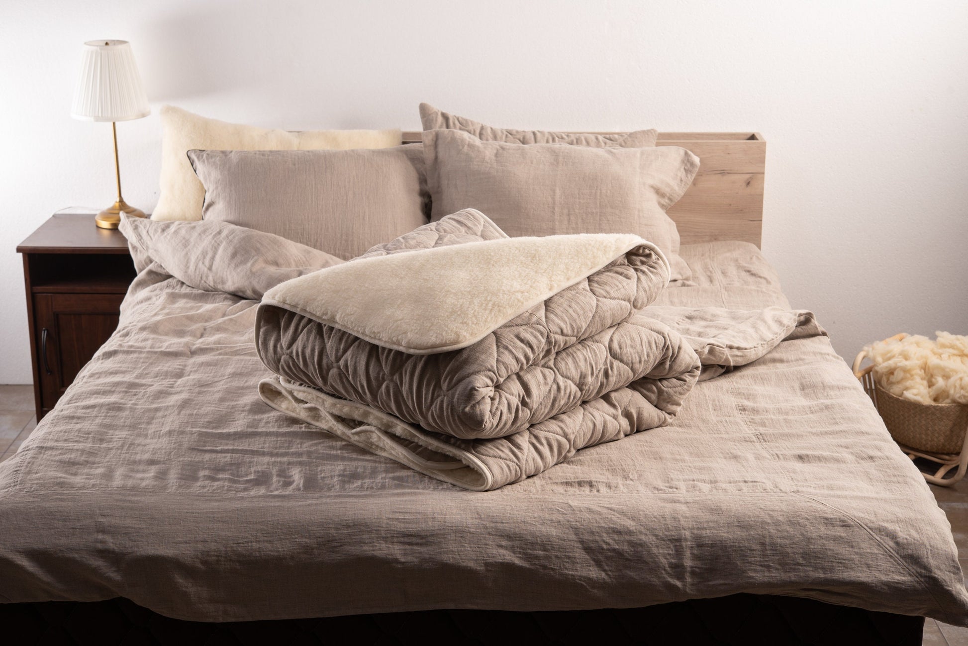 Linen and merino wool blanket folded on a bed