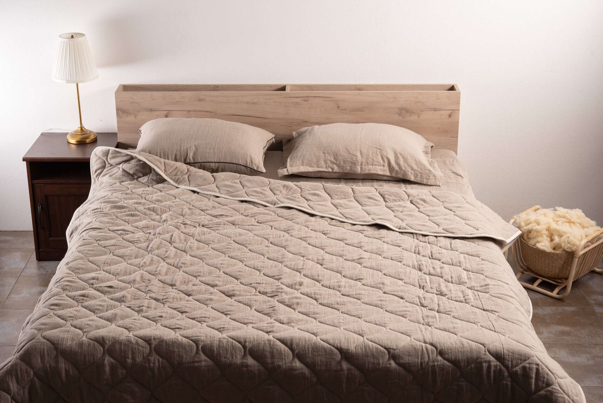 Linen and wool comforter on a bed 