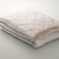 Folded wool and cotton sateen quilt. Handcrafted by Woolland